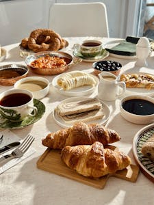 A vibrant assortment of traditional Turkish breakfast items, including tea, spreads, and pastries.