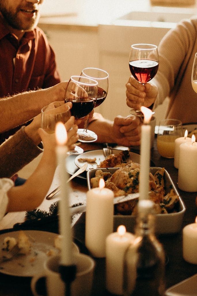 Warm family dinner scene with wine toasting and candlelight ambiance for a festive celebration.